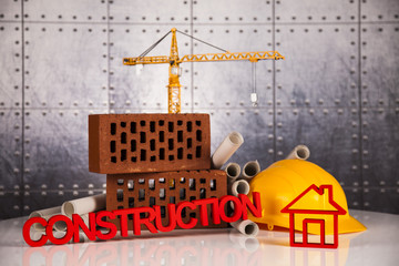 Construction plan with a crane and yellow helmet