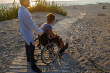 Young man in wheelchair and his doctor.