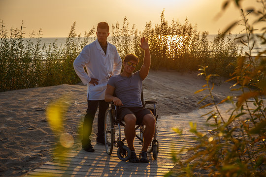 Young man in wheelchair and his doctor.