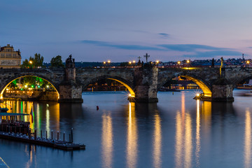 Fototapeta na wymiar Reflection of Prague castle and the Charles bridge at dusk