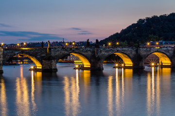 Reflection of Prague castle and the Charles bridge at dusk