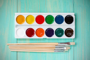 Watercolor paints with set of paint brushes