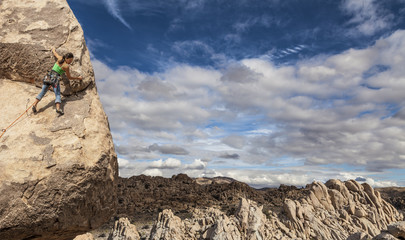 Rock climber clinging to a cliff.