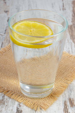 Glass of clean water with slice of lemon, cold lemonade