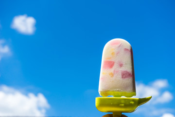Hand holding ice cream background sky 1