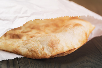 freshly baked flat bread on wood table