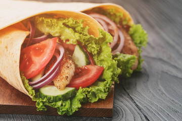 pair of fresh juicy tortilla wraps with chicken and vegetables