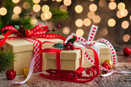 Christmas presents  and festive decor over wooden background