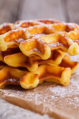 Belgian waffles sprinkled with powdered sugar,closeup.selective focus