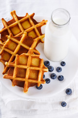 Belgian waffles with milk and fresh berries.selective focus