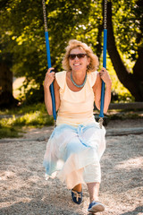 Senior woman on swing portrait