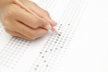 Obraz premium Standardized test form with answers bubbled in and a pencil, foc