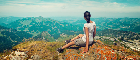 Woman Enjoying the View of Mountain Landscape - obrazy, fototapety, plakaty