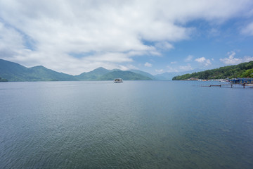 Lake Chuzenji with tourist boat near Nikko, Japan