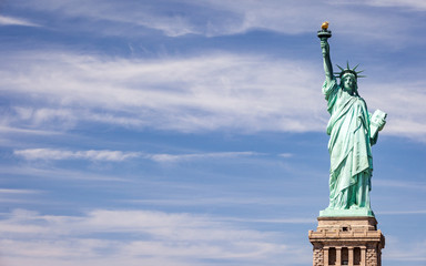 Obraz na płótnie Canvas Statue of Liberty, NYC, USA. A view of the familiar New York landmark set against a bright blue spring sky with copy space.