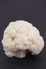 Closeup of cauliflower isolated on dark background.