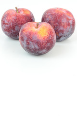 Closeup of ripe plums isolated on white.