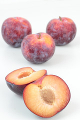 Closeup of ripe plums isolated on white.