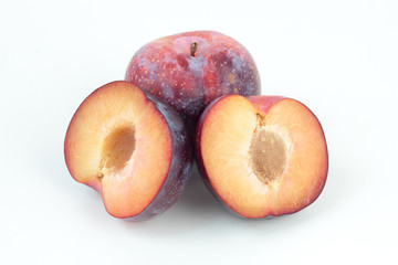 Closeup of ripe plums isolated on white.