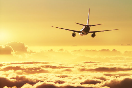 Fototapeta Airplane in the sky at sunset