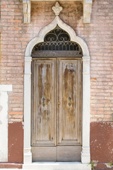 Fototapeta na wymiar Weathered, old wooden gate with fretwork