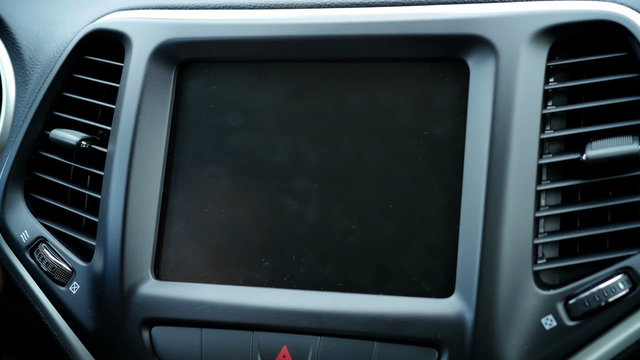 5392 A close up of view a person choosing an option on their in-dash touchscreen entertainment unit. With optional luma matte.	