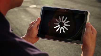 Man Waits for Download on Tablet PC