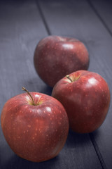 Red apples on a rustic background.