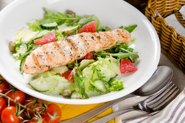 Salmon grilled with mixed salad of fresh fruits and vegetables