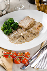 medallions of pork stewed with mushrooms in a creamy garlic sauc