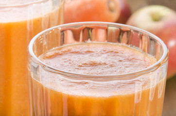 fresh carrot and apple smoothie in a glass
