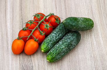 Cucumbers and tomatoes on the branch