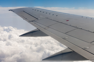 Fototapeta na wymiar Beautiful view of airplane wing on blue sky background