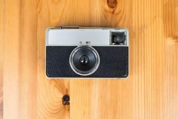 Old retro camera on vintage wooden background
