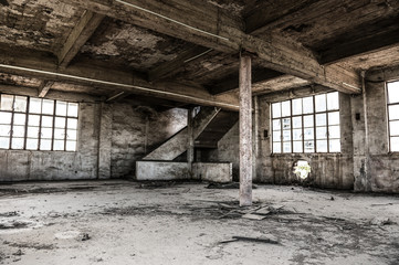 Lege industriële loft in een architecturale achtergrond met kale cementmuren, vloeren en pilaren die een mezzanine ondersteunen