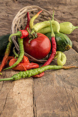 fresh vegetables in a basket on wooden table