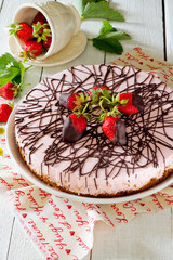 Cake ice cream with strawberries on a wooden table