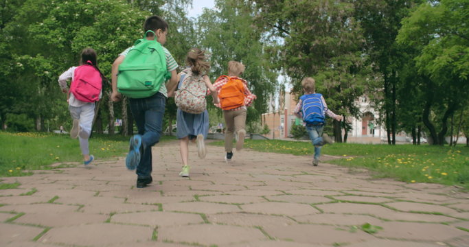 Group of pupils racing through schoolyard  