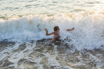 boy swimming in the sea on the waves
