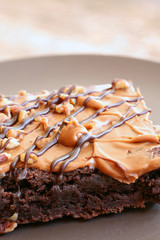 Large cake chocolate brownie on a plate using a wooden background
