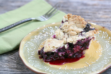 Slice of Blueberry Pie on rustic wooden table