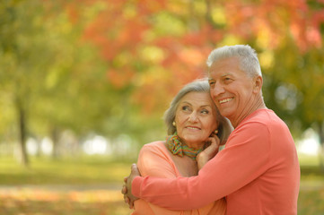 Senior couple relax in autumn park