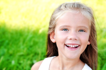 Portrait of smiling cute little girl in summer day