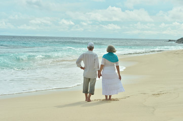 Fototapeta na wymiar Elderly couple rest at tropical resort