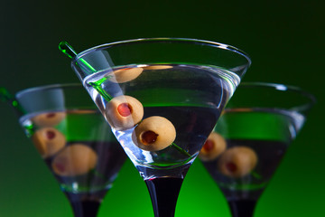 glasses with martini and green olives