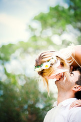Beautiful happy young couple in white dresses is kissing smiling in the park in summer - 90830662