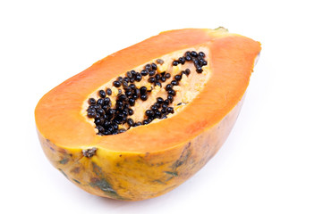 Cutted ripe papaya on black background.