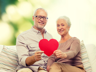 happy senior couple with red heart shape