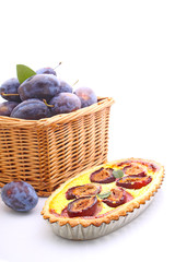 tart of pastry with plums on a white background
