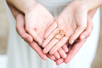Couple hands holding engagement rings  - 90832420